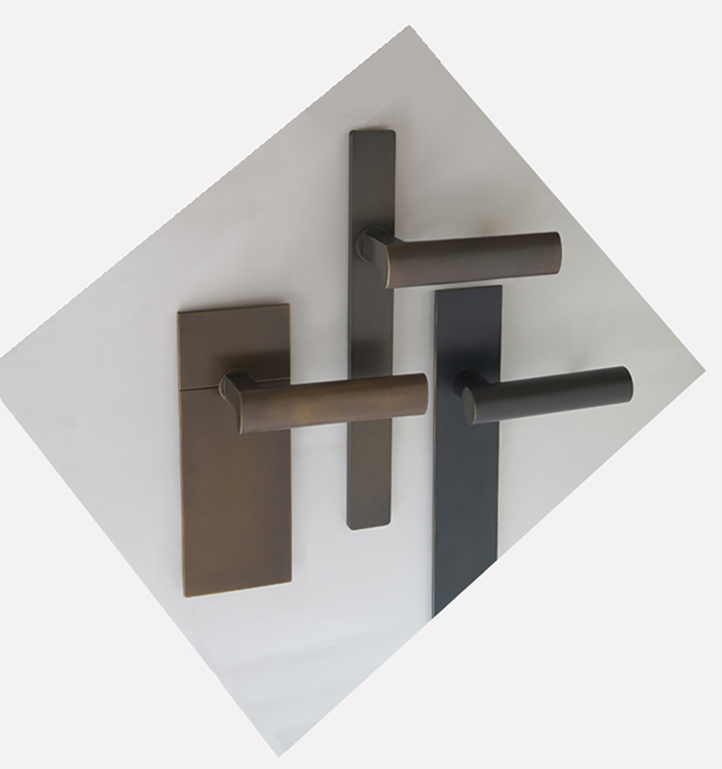 Three modern and minimalist door handles in dark finishes on oversized backplates